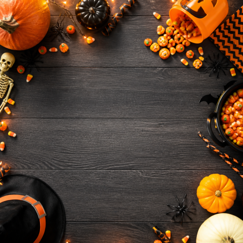 Halloween pumpkin candy dark wood background