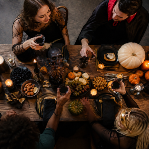 People around halloween dinner table overhead view