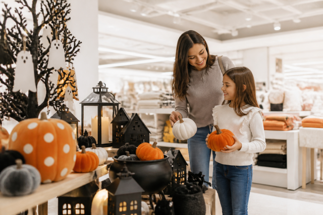 Woman child shopping halloween decorations store